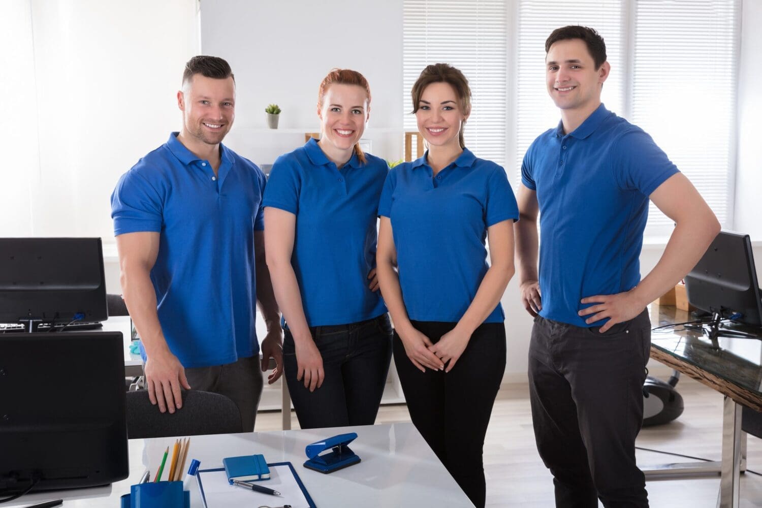 Portrait Of A Smiling Janitors In Uniform At Office